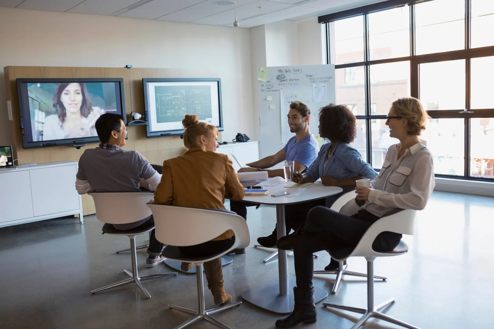 Coworkers watching TV in an office break room